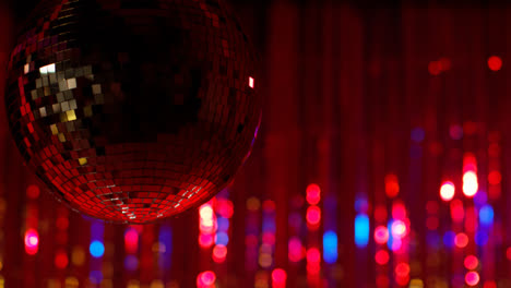 Close-Up-Of-Mirrorball-In-Night-Club-Or-Disco-With-Flashing-Strobe-Lighting-And-Sparkling-Lights-In-Background-1
